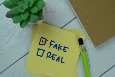 Concept of Are you Eligible? write on sticky notes isolated on Wooden Table.の写真素材