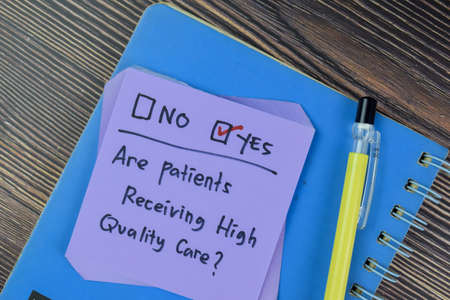 Concept of Have you done Annual Colorectal Screening? Yes write on a book isolated on Wooden Table.の写真素材