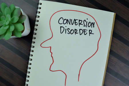 Concept of Conversion Disorder write on a book isolated on Wooden Table.の写真素材