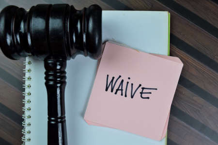 Concept of Restitution write on sticky notes with gavel isolated on Wooden Table.