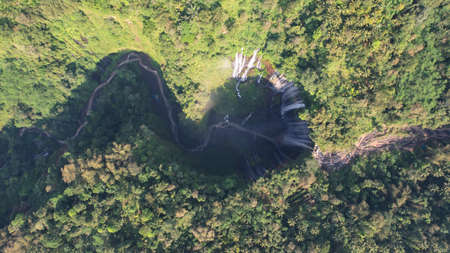Aerial view of Tumpak Sewu waterfall and Semeru mountain at sunrise located in Lumajang. East Java, Indonesia, August 28, 2022の写真素材