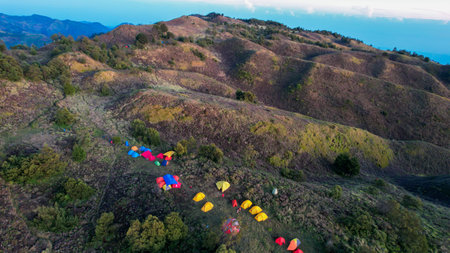 Aerial view of beauty mountain peaks Prau Dieng, Central Java and the climbers and tent. Wonosobo, Indonesia, September 30, 2022の写真素材
