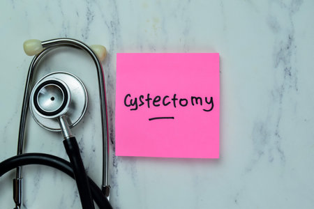 Concept of Cystectomy write on sticky notes with stethoscope isolated on Wooden Table.