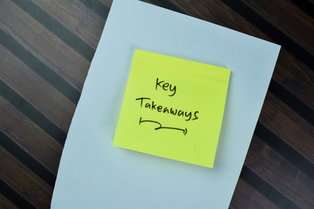 Concept of Key Takeaways write on sticky notes isolated on Wooden Table.の写真素材