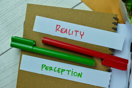 Concept of Reality or Perception write on sticky notes isolated on Wooden Table.の写真素材