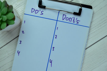 Concept of Do's and Don'ts write on paperwork isolated on Wooden Table.