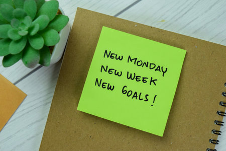Concept of New Monday, New Week, New Goals write on sticky notes isolated on Wooden Table.の写真素材
