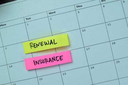 Concept of Renewal Insurance write on sticky notes isolated on Wooden Table.