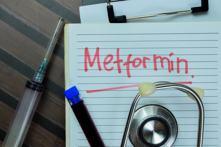 Concept of Metformin write on book with stethoscope isolated on Wooden Table.