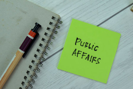 Concept of Public Affairs write on sticky notes isolated on Wooden Table.の写真素材
