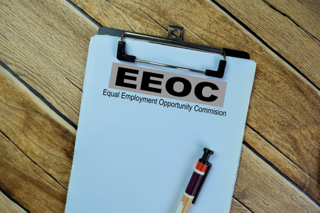 Concept of EEOC - Equal Employment Opportunity Commision write on paperwork isolated on Wooden Table.の写真素材