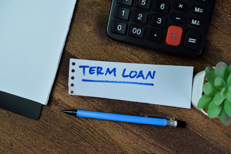 Concept of Term Loan write on sticky notes isolated on Wooden Table.