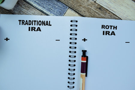 Concept of Traditional IRA and Roth IRA write on book isolated on Wooden Table.の写真素材