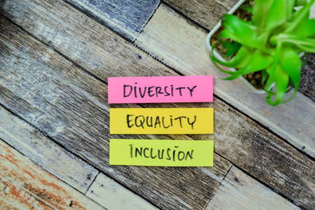 Concept of Diversity, Equality, Inclusion write on sticky notes isolated on Wooden Table.の写真素材