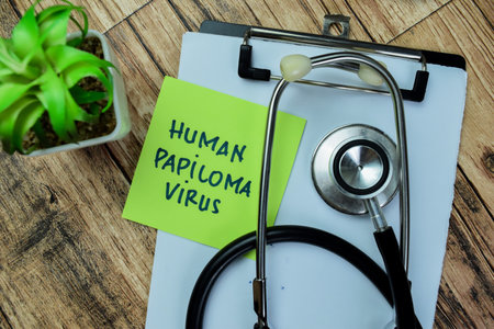 Concept of Human Papiloma Virus write on sticky notes isolated on Wooden Table.の写真素材