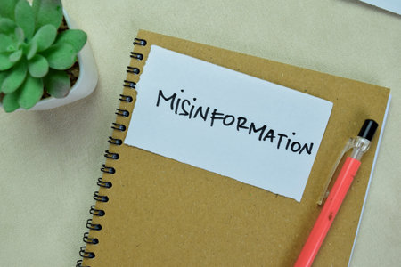 Concept of Misinformation write on sticky notes isolated on Wooden Table.の写真素材