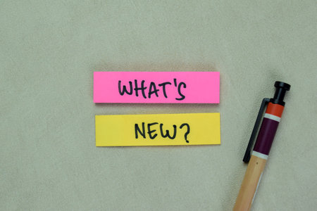 Concept of What's New? write on sticky notes isolated on Wooden Table.の写真素材