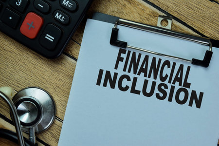Concept of Finansial Inclusion write on paperwork isolated on Wooden Table.の写真素材