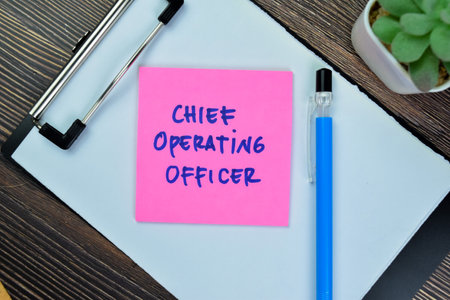Concept of Chief Operating Officer write on sticky notes isolated on Wooden Table.の写真素材
