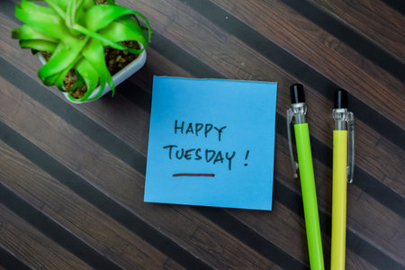 Concept of Happy Tuesday write on sticky notes isolated on Wooden Table.の写真素材