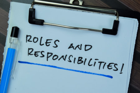 Concept of Roles and Responsibilities write on paperwork isolated on Wooden Table.の写真素材