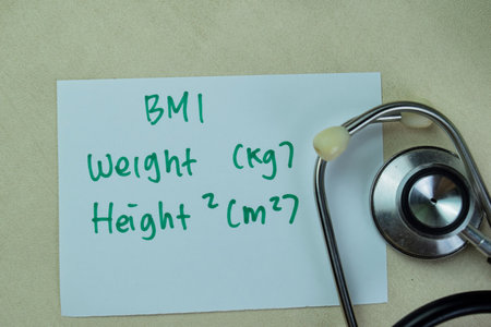 Concept of BMI - Weight and Height write on sticky notes with stethoscope isolated on Wooden Table.の写真素材