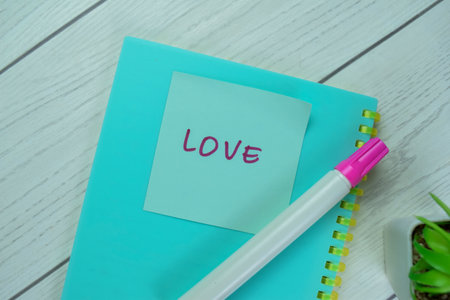 Concept of Love write on sticky notes isolated on Wooden Table.の写真素材