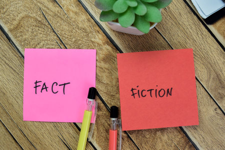 Concept of Fact or Opinion write on sticky notes isolated on Wooden Table.