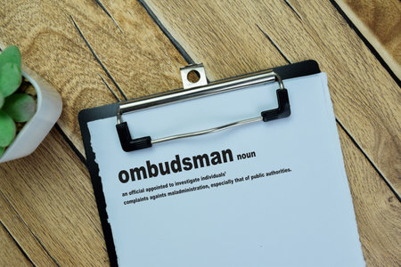 Concept of Definition Ombudsman word write on paperwork isolated on Wooden Table.の写真素材