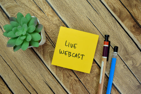 Concept of Live Webcast write on sticky notes isolated on Wooden Table.の写真素材