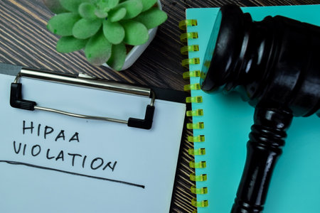 Concept of HIPAA Violation write on paperwork isolated on Wooden Table.の写真素材