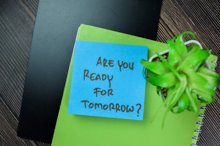 Concept of Are You Ready For Tomorrow write on sticky notes isolated on Wooden Table.の写真素材