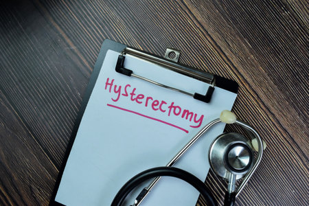 Concept of Hysterectomy write on sticky notes with stethoscope isolated on Wooden Table.