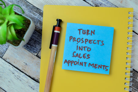 Concept of Turn Prospects Into Sales Appointments write on sticky notes isolated on Wooden Table.の写真素材