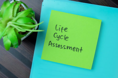 Concept of Life Cycle Assessment write on sticky notes isolated on Wooden Table.の写真素材