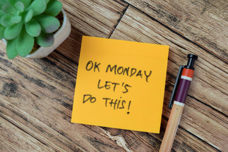 Concept of OK Monday Let's Do This! write on sticky notes isolated on Wooden Table.の写真素材