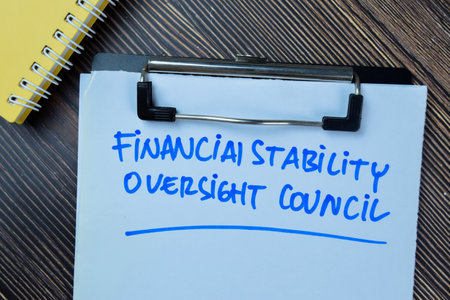 Concept of Financial Stability Oversight Council write on paperwork isolated on Wooden Table.