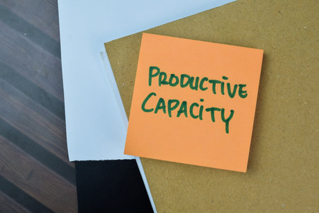 Concept of Productive Capacity write on sticky notes isolated on Wooden Table.の写真素材