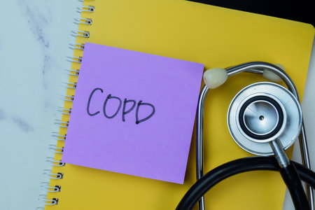 Concept of COPD write on sticky notes with stethoscope isolated on Wooden Table.の写真素材