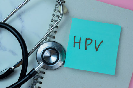 Concept of HPV write on sticky notes with stethoscope isolated on Wooden Table.の写真素材