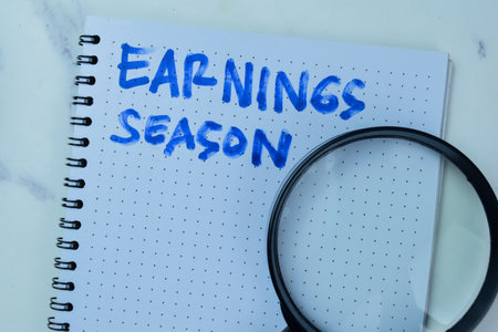 Concept of Earnings Season write on book isolated on Wooden Table.の写真素材