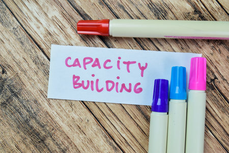 Concept of Capacity Building write on sticky notes isolated on Wooden Table.の写真素材