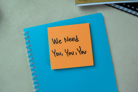 Concept of We Need You, You, You write on sticky notes isolated on Wooden Table.の写真素材