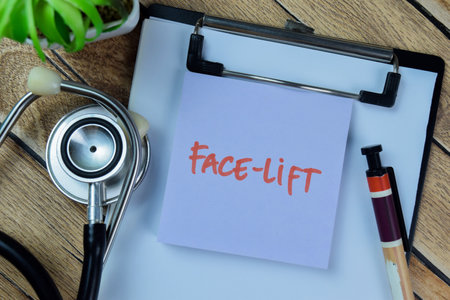 Concept of Face-Lift write on sticky notes with stethoscope isolated on Wooden Table.
