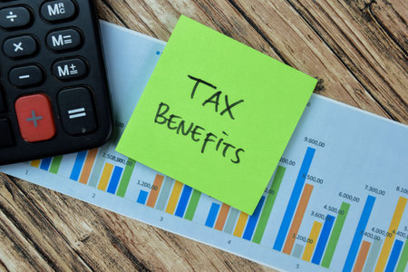 Concept of Tax Benefits write on sticky notes isolated on Wooden Table.の写真素材