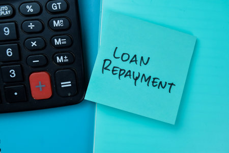 Concept of Loan Repayment write on sticky notes isolated on Wooden Table.の写真素材