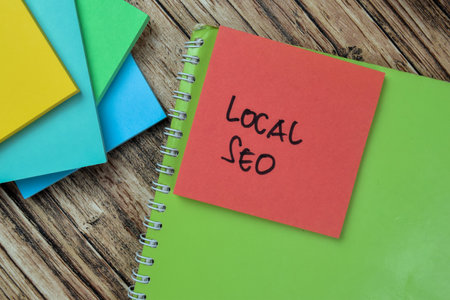 Concept of Local SEO write on sticky notes isolated on Wooden Table.の写真素材