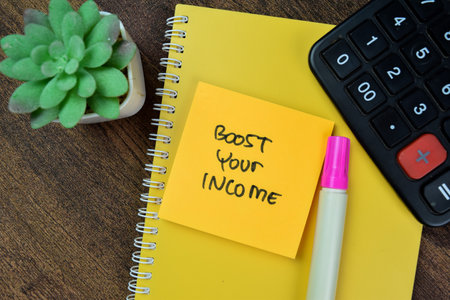 Concept of Boost Your Income write on sticky notes isolated on Wooden Table.の写真素材