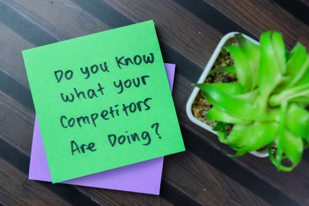 Concept of Do You Know What Your Competitors Are Doing? write on sticky notes isolated on Wooden Table.の写真素材