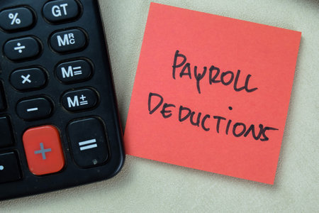 Concept of Payroll Deductions write on sticky notes isolated on Wooden Table.